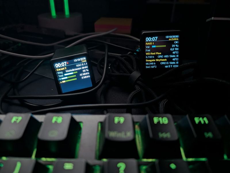 Two SmallTV Ultra with KAC firmware on a desk, a test page on the left, the NAS page with RAID status and disk temperatures on the right